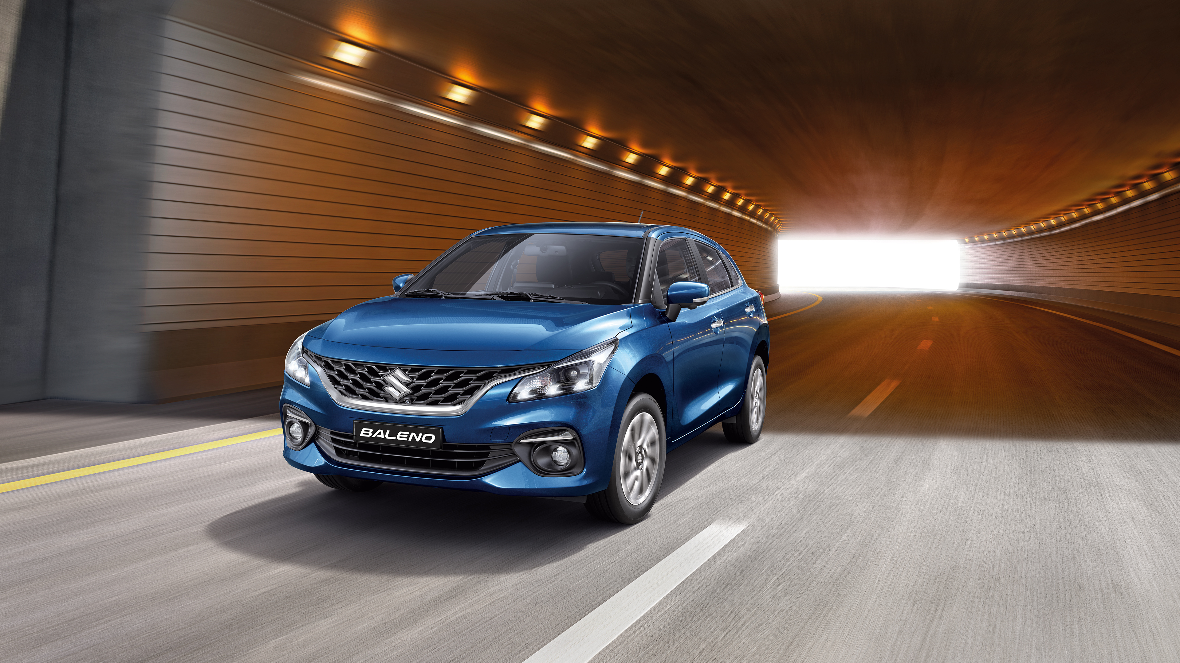 Suzuki Baleno driving on highway through tunnel